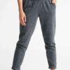 Crimson and charcoal football training tracksuit. Close-up shows breathable fabric, reinforced stitching. Jacket and pants se