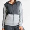 Crimson and charcoal football training tracksuit. Close-up shows breathable fabric, reinforced stitching. Jacket and pants se