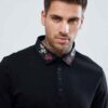 Close-up of custom polo: vibrant blue cotton, crisp embroidered design, fine stitching. Soft, breathable fabric visible. - Vi