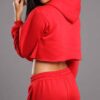 Red-hot ladies sweatsuit featuring a cropped top. Soft, textured fabric with visible stitching. Perfect for casual style and