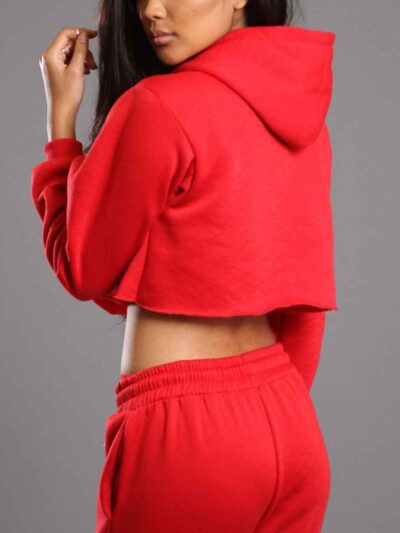 Red-hot ladies sweatsuit featuring a cropped top. Soft, textured fabric with visible stitching. Perfect for casual style and