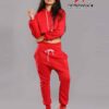 Red-hot ladies sweatsuit featuring a cropped top. Soft, textured fabric with visible stitching. Perfect for casual style and