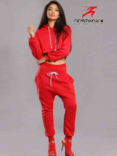 Red-hot ladies sweatsuit featuring a cropped top. Soft, textured fabric with visible stitching. Perfect for casual style and