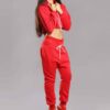 Red-hot ladies sweatsuit featuring a cropped top. Soft, textured fabric with visible stitching. Perfect for casual style and