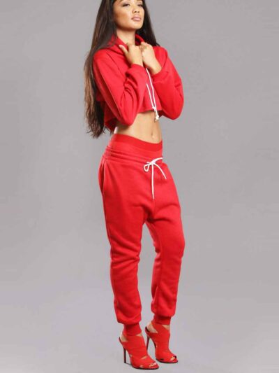 Red-hot ladies sweatsuit featuring a cropped top. Soft, textured fabric with visible stitching. Perfect for casual style and
