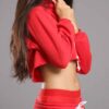 Red-hot ladies sweatsuit featuring a cropped top. Soft, textured fabric with visible stitching. Perfect for casual style and