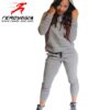 Fitted ladies' sweatsuit in soft heather grey. Skinny leg cut, ribbed cuffs and waistband, subtle topstitching detail visible