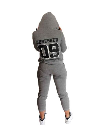 Fitted ladies' sweatsuit in soft heather grey. Skinny leg cut, ribbed cuffs and waistband, subtle topstitching detail visible