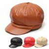 Close-up of a stylish snapback cap featuring a rich leather patch. Notice the textured fabric, intricate stitching, and class