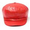 Close-up of a stylish snapback cap featuring a rich leather patch. Notice the textured fabric, intricate stitching, and class