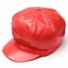Close-up of a stylish snapback cap featuring a rich leather patch. Notice the textured fabric, intricate stitching, and class