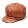 Close-up of a stylish snapback cap featuring a rich leather patch. Notice the textured fabric, intricate stitching, and class