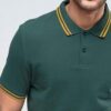 Close-up of a lightweight polo shirt, likely polyester knit. Bright, fully sublimated design with fine stitching visible at t