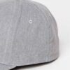 Grey men's cap with subtle textured fabric. Curved brim, clean stitching. Adjustable back closure. Casual, understated style.