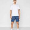Men's gym set: breathable athletic shorts and fitted tee. Notice fine stitching, soft-touch fabric, and subtle color gradient