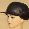 Leather driving cap with plush fleece lining. Warm winter hat, flat style, ear flaps. Fine stitching detail visible on smooth