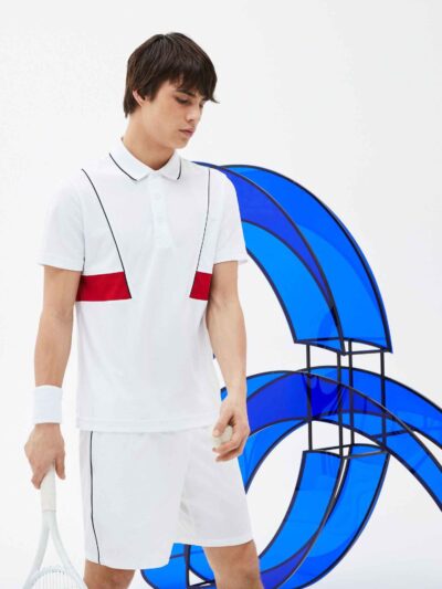 Men's sports polo shirt featuring colorful blocks design and custom embroidered logo. Fabric has a soft, breathable texture w
