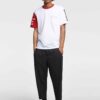Men's crewneck tee showing custom design area. Soft cotton texture, reinforced stitching. Solid color backdrop highlights per