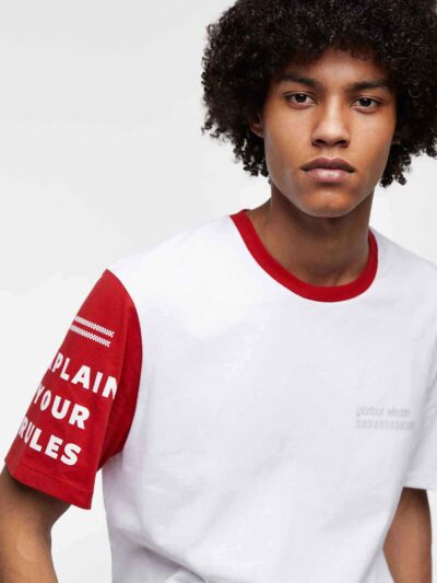 Men's crewneck tee showing custom design area. Soft cotton texture, reinforced stitching. Solid color backdrop highlights per