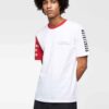 Men's crewneck tee showing custom design area. Soft cotton texture, reinforced stitching. Solid color backdrop highlights per