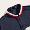 Classic short sleeve polo shirt in a rich blue hue; fine cotton knit texture with neat, custom embroidery detail on the chest