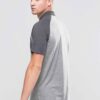 Men's slim fit polo shirt, fine knit texture, pique weave, crisp collar, button placket. Subtle heather grey hints. Professio