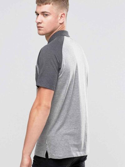 Men's slim fit polo shirt, fine knit texture, pique weave, crisp collar, button placket. Subtle heather grey hints. Professio