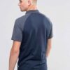 Men's slim fit polo shirt, fine knit texture, pique weave, crisp collar, button placket. Subtle heather grey hints. Professio
