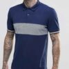 Close-up: Navy blue men's polo shirt. Soft pique knit texture, clean stitching. Classic short sleeves, subtle collar, custom
