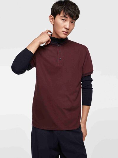 Close-up of a cotton polo shirt, showcasing fine pique knit texture and clean stitching. Casual top with subtle color variati