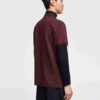 Close-up of a cotton polo shirt, showcasing fine pique knit texture and clean stitching. Casual top with subtle color variati