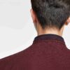 Close-up of a cotton polo shirt, showcasing fine pique knit texture and clean stitching. Casual top with subtle color variati