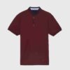 Close-up of a cotton polo shirt, showcasing fine pique knit texture and clean stitching. Casual top with subtle color variati