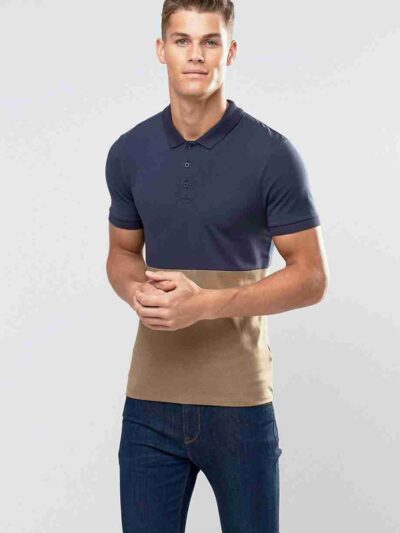 Close-up of a textured pique polo shirt. Notice the quality stitching, custom logo, and button placket. Light blue hue, breat