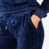 Navy velour loungewear set. Pullover hoodie with matching bottoms. Soft, plush texture with subtle sheen. Clean stitching, re