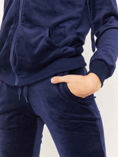Navy velour tracksuit. Close-up shows plush velvet texture, zip-front hoodie, ribbed cuffs. Luxurious and comfortable. - View