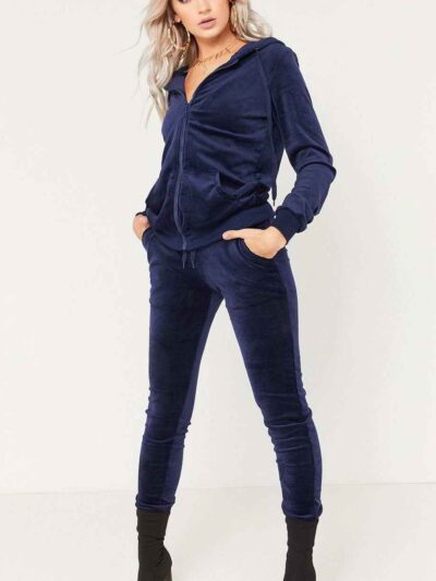 Navy velour tracksuit. Close-up shows plush velvet texture, zip-front hoodie, ribbed cuffs. Luxurious and comfortable. - View