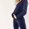 Navy velour tracksuit. Close-up shows plush velvet texture, zip-front hoodie, ribbed cuffs. Luxurious and comfortable. - View