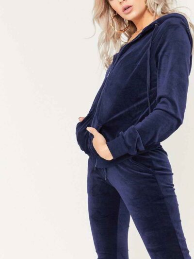 Navy velour tracksuit. Close-up shows plush velvet texture, zip-front hoodie, ribbed cuffs. Luxurious and comfortable. - View