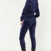 Navy velour tracksuit. Close-up shows plush velvet texture, zip-front hoodie, ribbed cuffs. Luxurious and comfortable. - View