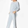 Grey women's tracksuit with sporty white side stripes. Soft knit texture, tailored fit. Activewear set for workouts or loungi