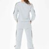 Grey women's tracksuit with sporty white side stripes. Soft knit texture, tailored fit. Activewear set for workouts or loungi