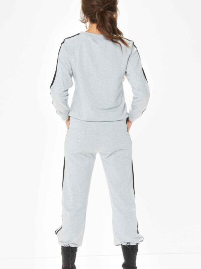 Grey women's tracksuit with sporty white side stripes. Soft knit texture, tailored fit. Activewear set for workouts or loungi