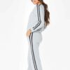 Grey women's tracksuit with sporty white side stripes. Soft knit texture, tailored fit. Activewear set for workouts or loungi