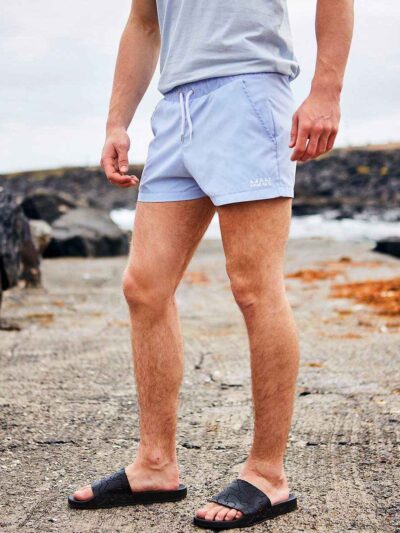 Close-up of athletic shorts. Moisture-wicking fabric, subtle sheen, reinforced stitching. Performance garment, available in c