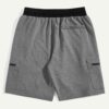 Camo beach shorts. Lightweight, breathable fabric with detailed stitching. Green, brown, and tan camouflage print. Elastic wa