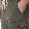 Men's vibrant swim trunks with breathable mesh lining. Close up shows sturdy stitching and quick-drying fabric. Ideal for res