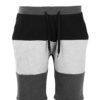 Close-up of charcoal sweat shorts featuring a raised, detailed embroidered logo. Soft, looped-back cotton fabric. Premium sti