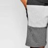 Close-up of charcoal sweat shorts featuring a raised, detailed embroidered logo. Soft, looped-back cotton fabric. Premium sti