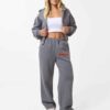Cropped zip hoodie and sweatpants set. Soft, peach-fuzz fabric. Visible stitching detail. Sporty, feminine loungewear in blus